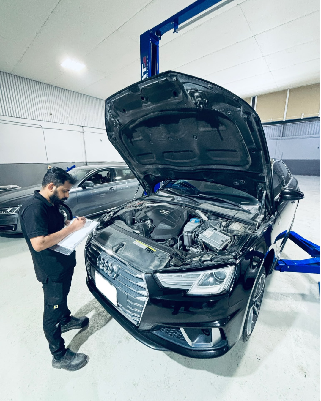 Audi engine being inspected by a technician